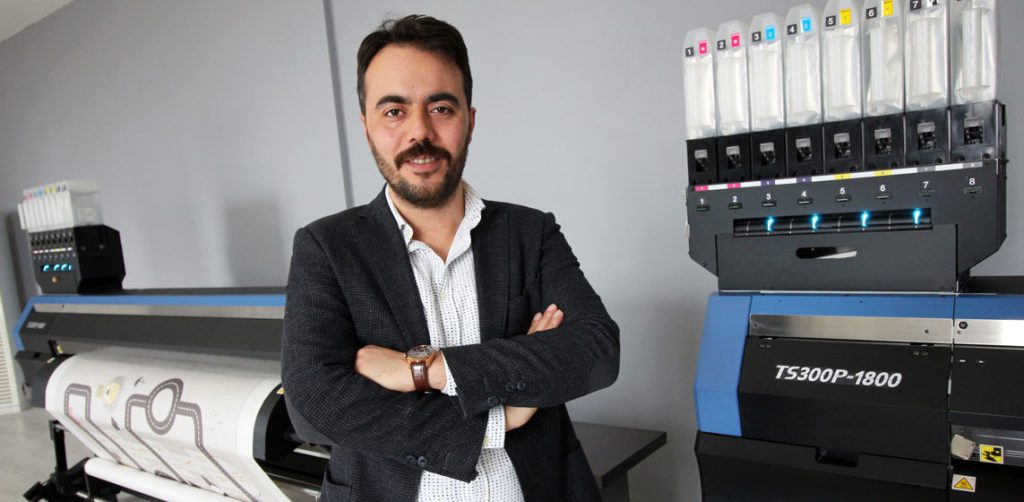 man in front of printer