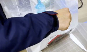 Operator applying DTF powder to DTF FIlm